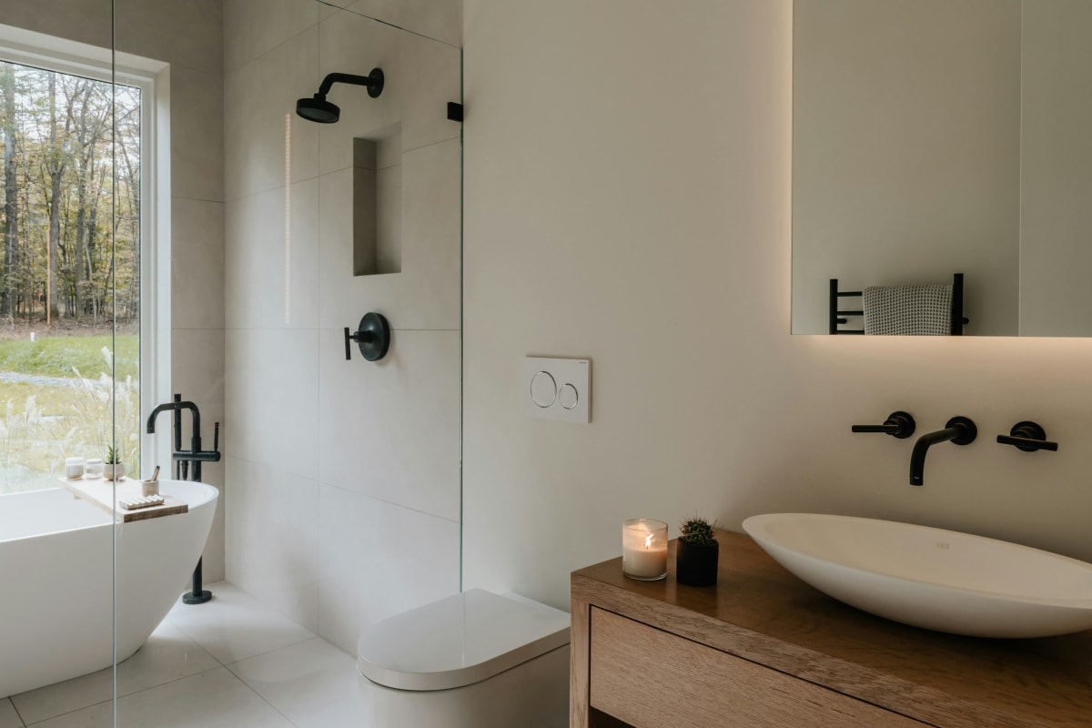 Bright bathroom with a soaking tub, wall-hung toilet and vessel sink