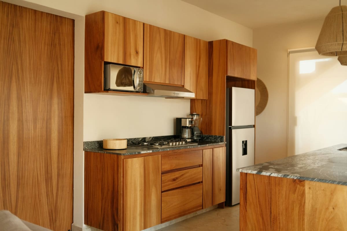 Warm wood kitchen cabinets with stone counters