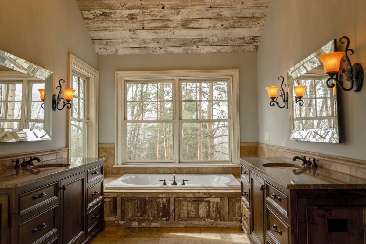 Bathroom with dark wood vanities and a soaking tub