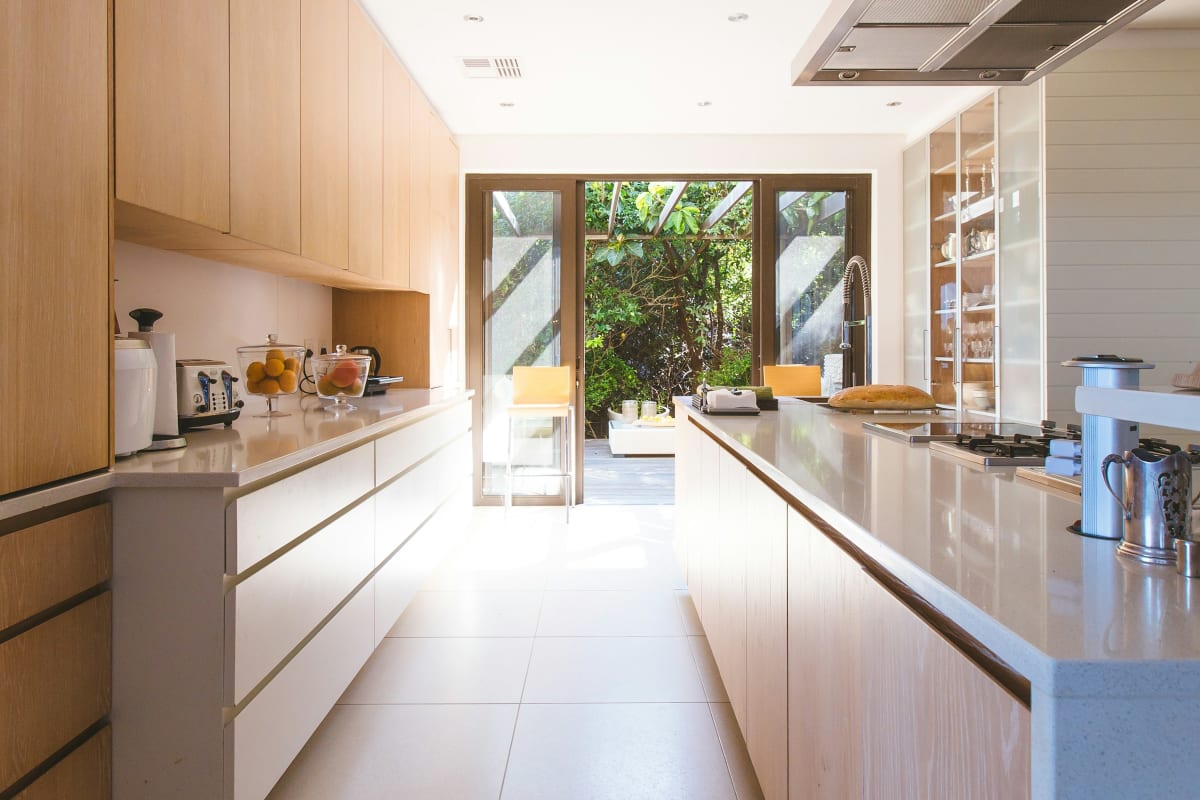 Bright kitchen with long runs of light wood cabinets