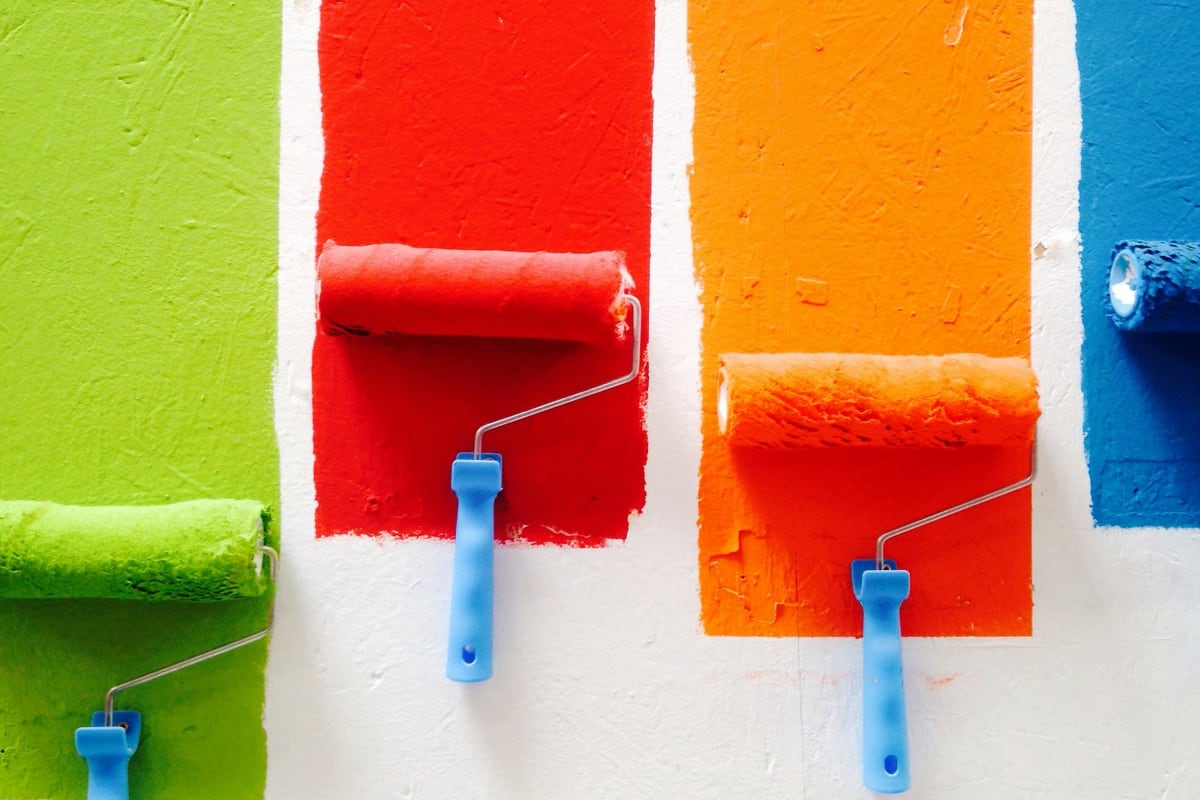 Rollers painting bright stripes of color