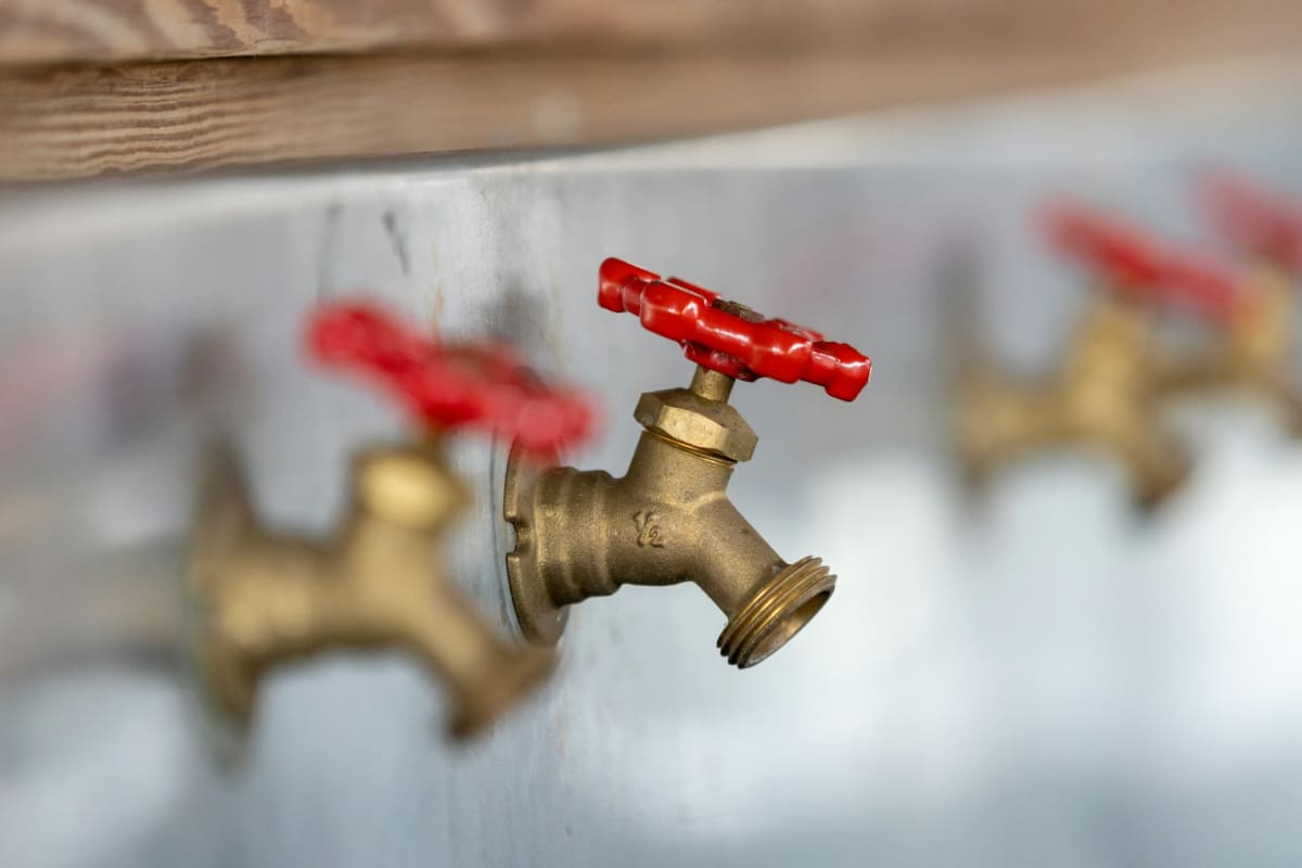 Brass hose bibs with red handles