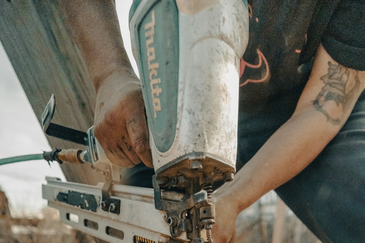 Framing nailer fastening boards on the job