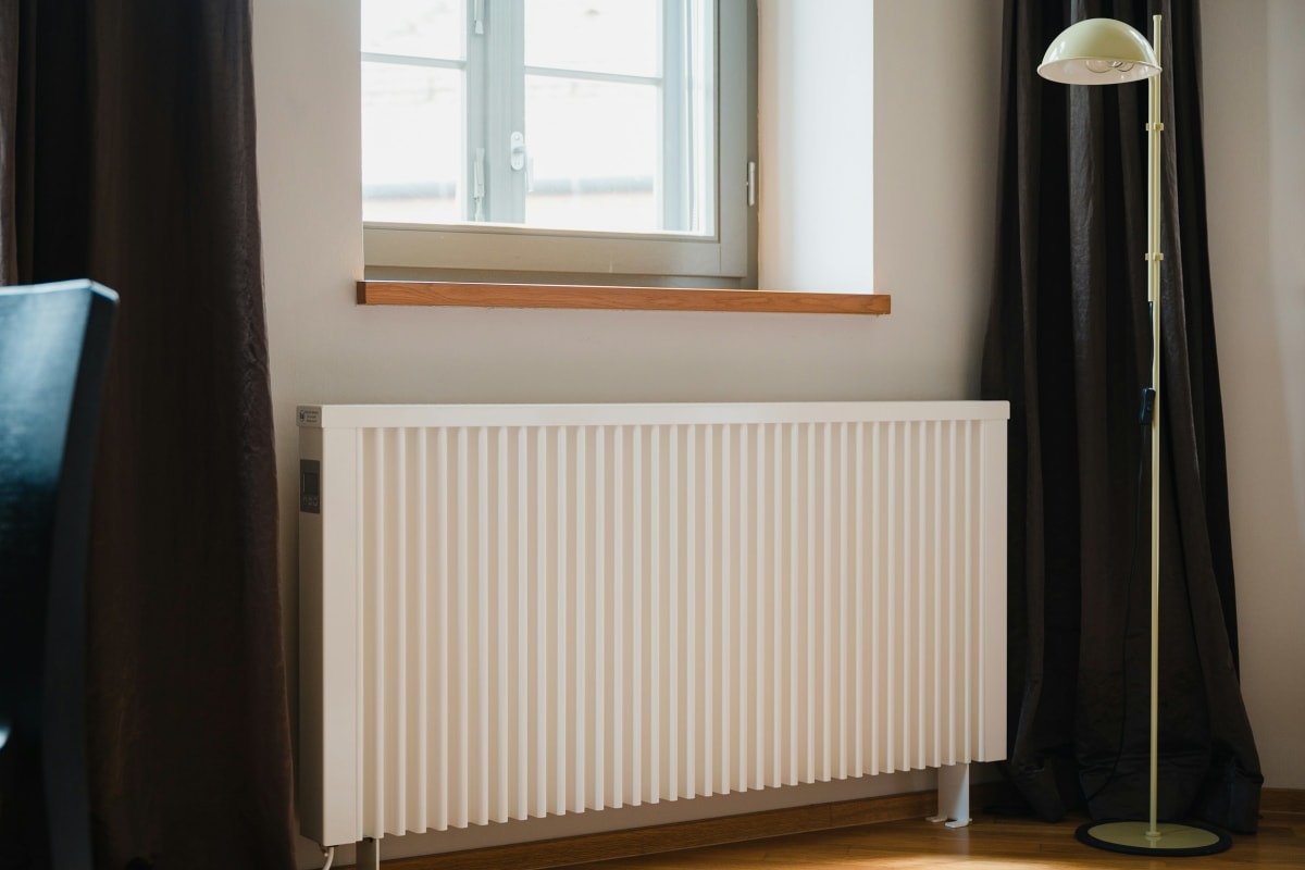 Electric wall heater under a window