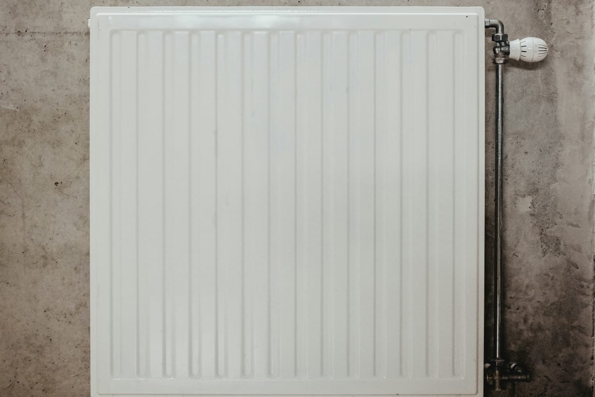 Wall-mounted electric heater on a concrete wall