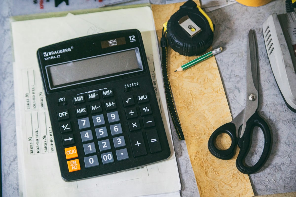 Calculator with a tape measure, pencils and plans