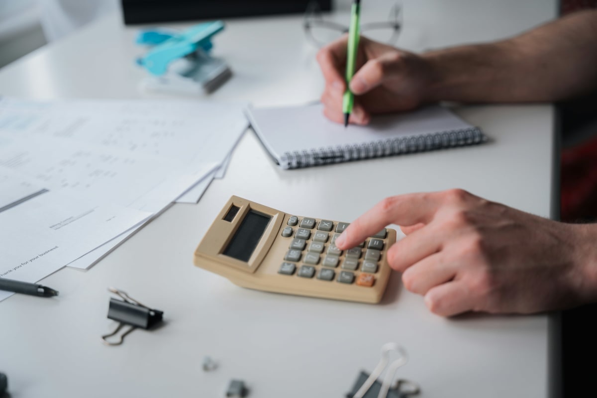 Working through numbers on a calculator at a desk