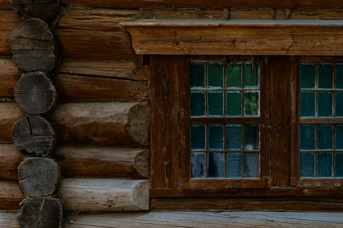 Log home wall with a wood-framed window