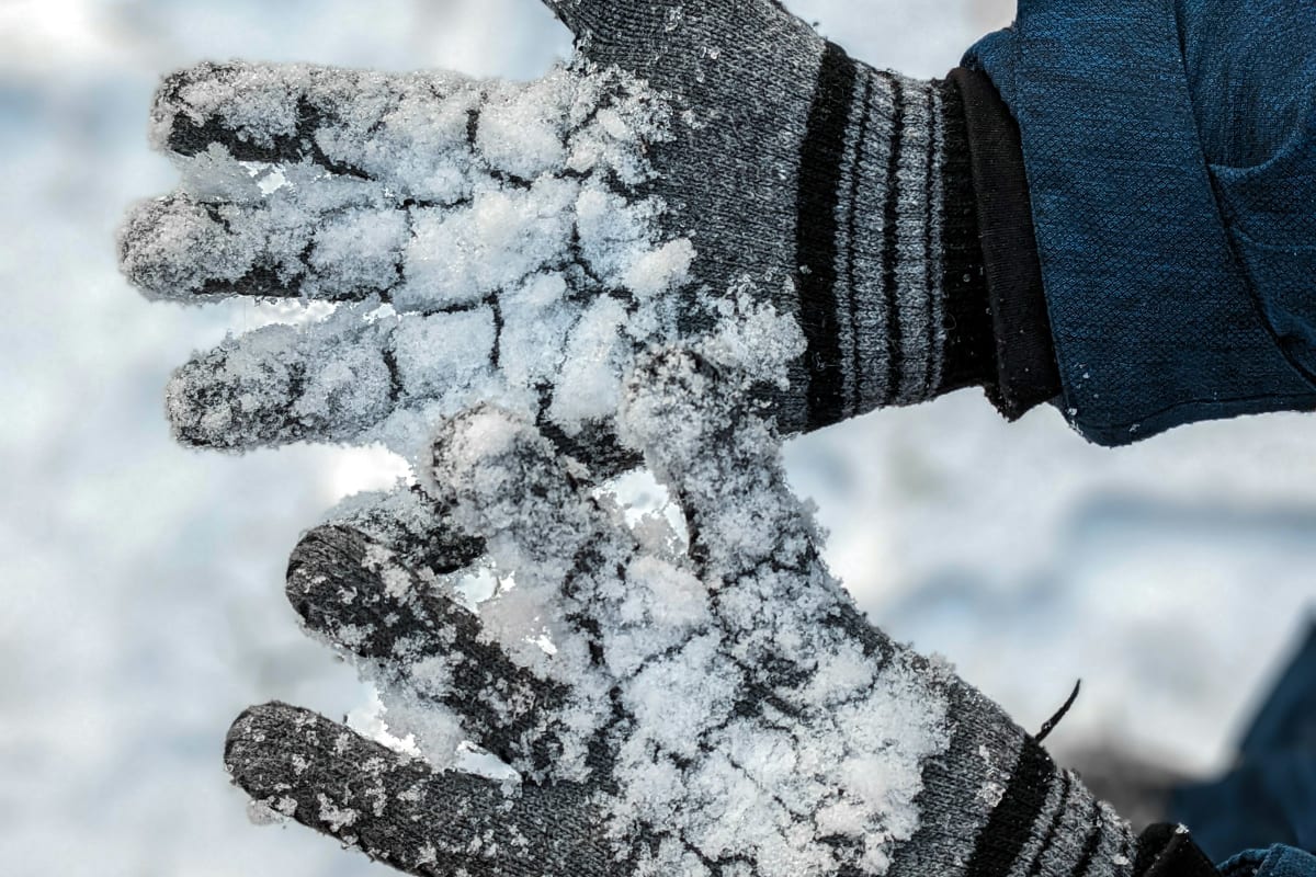 Snow-covered gloves in winter