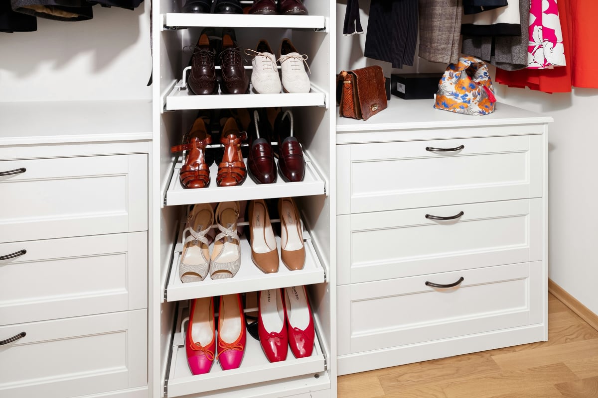 White closet with shoe shelves and drawers