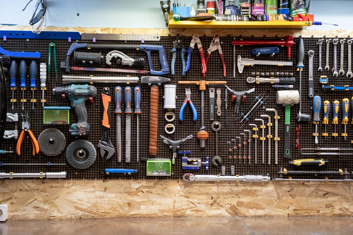 Pegboard tool wall above a workbench