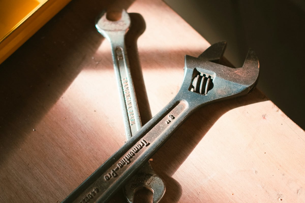 Adjustable wrench in the sunlight on a bench