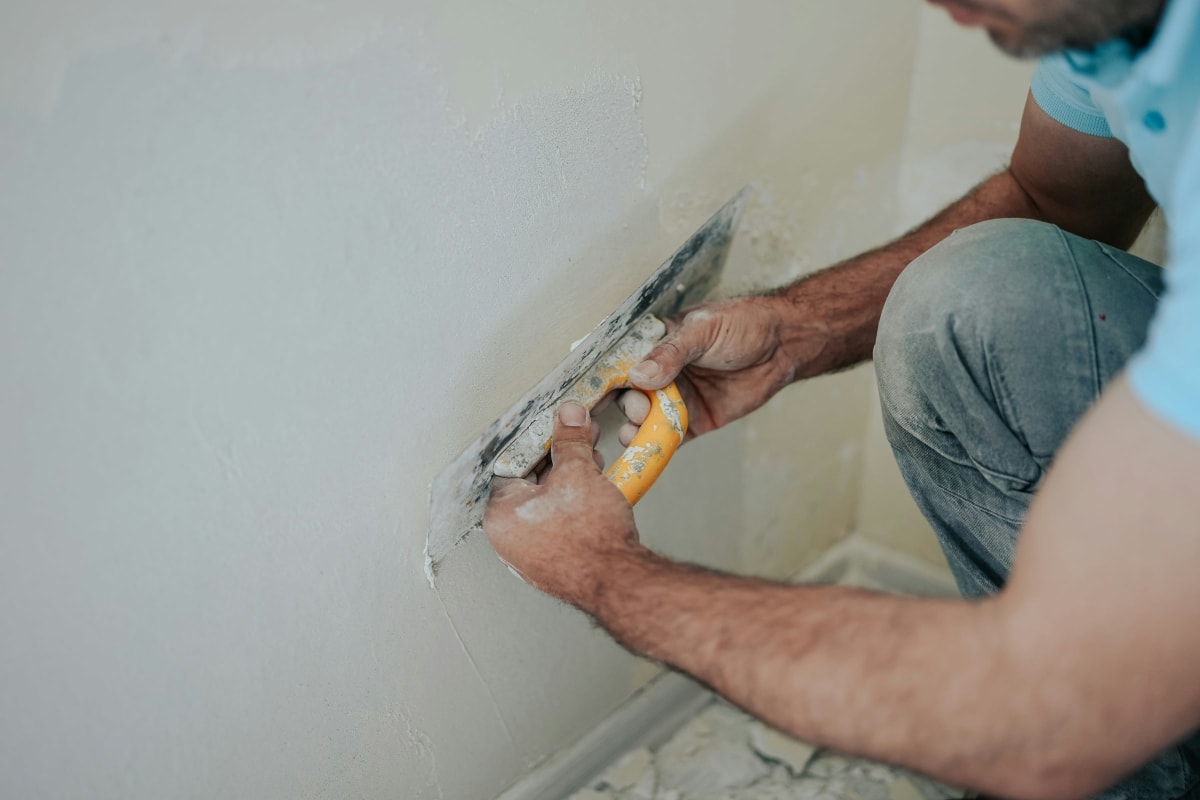 Patching a wall with a putty knife