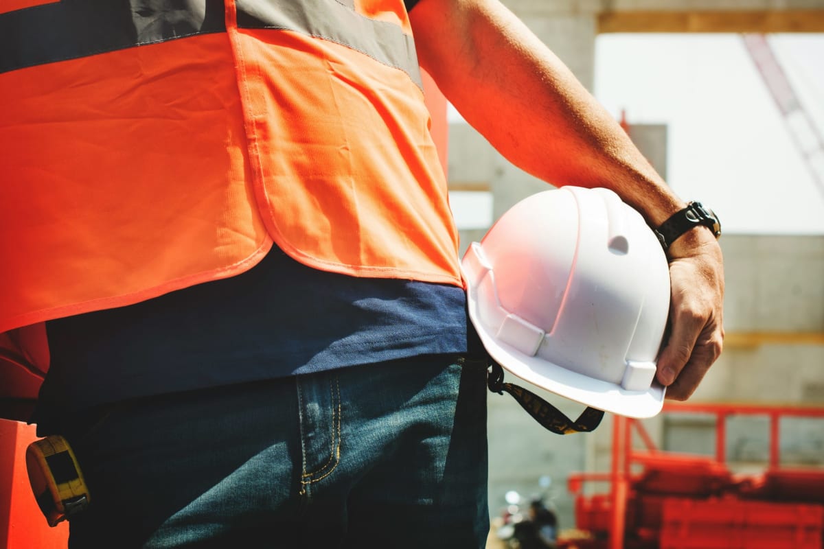 Worker carrying a white hard hat