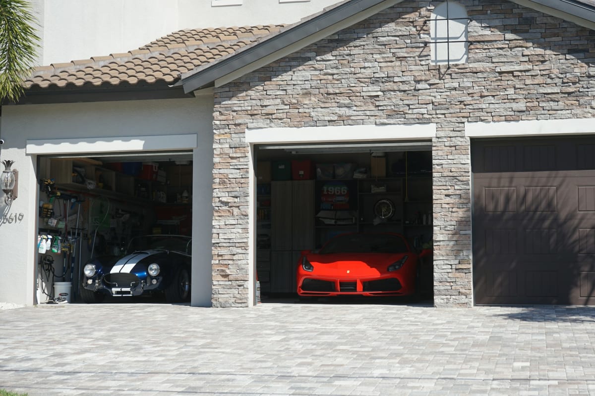Stone house with open garage doors
