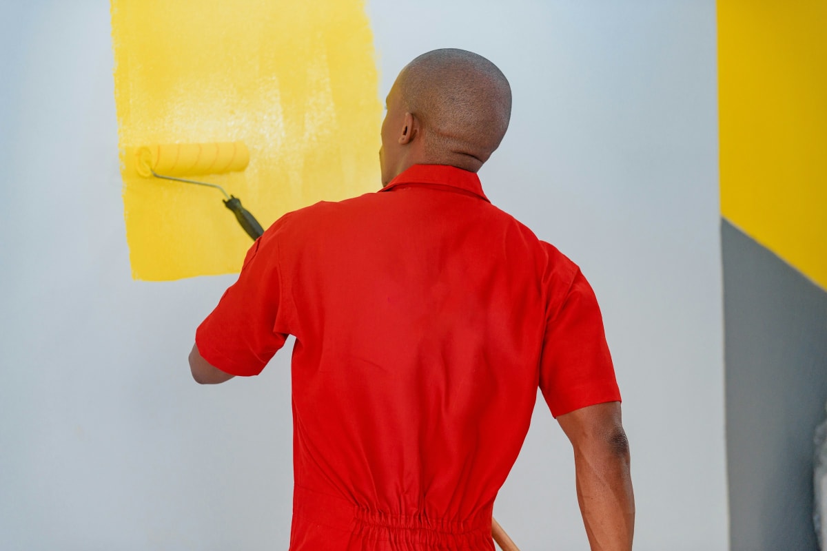 Painting a wall yellow with a roller