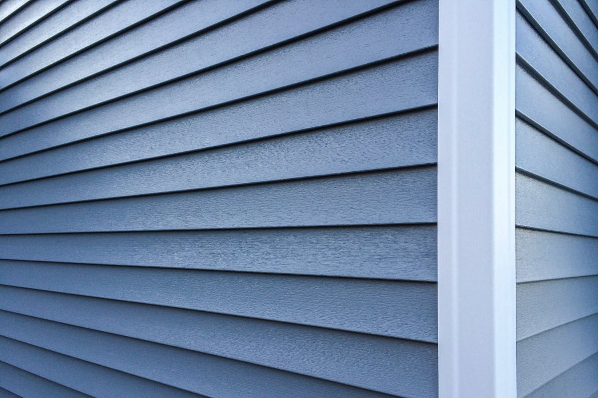 Close-up of blue lap siding at a corner