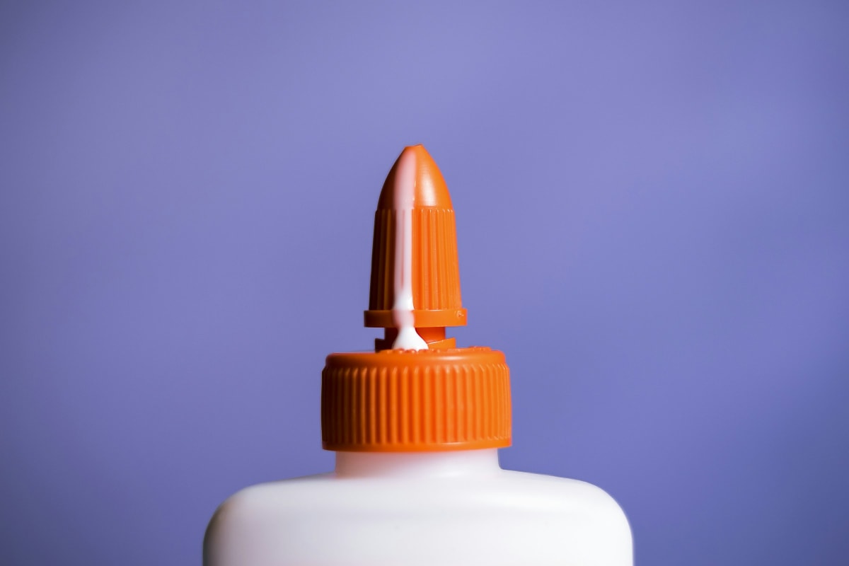White glue bottle with an orange cap