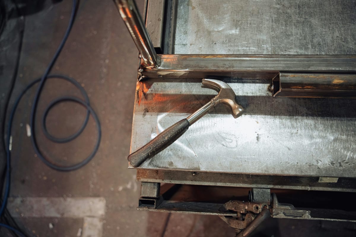 Hammer resting on a sheet metal box
