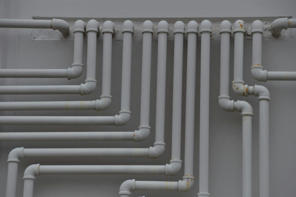 Gray pipes running along a wall