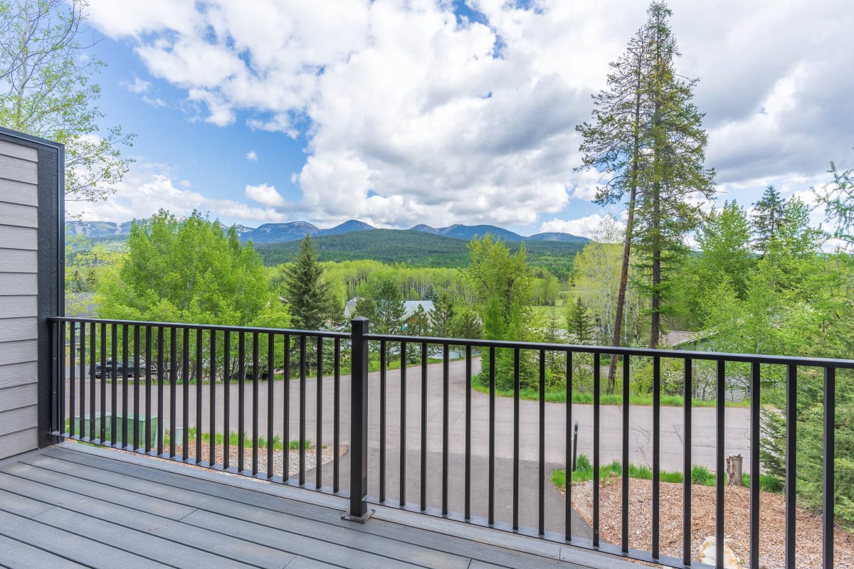 Black metal railing on a deck looking out to the mountains