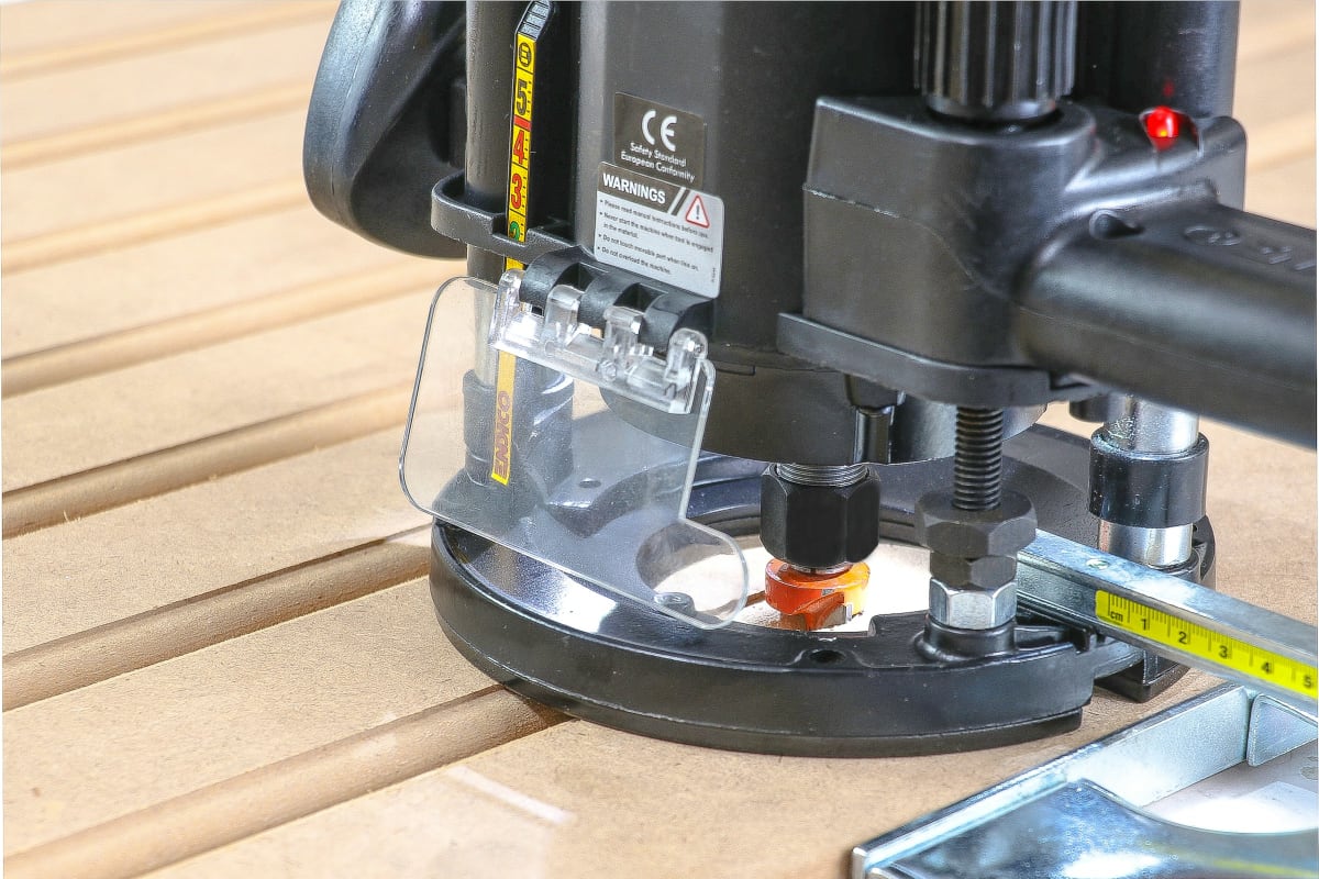 Router cutting a groove in a board