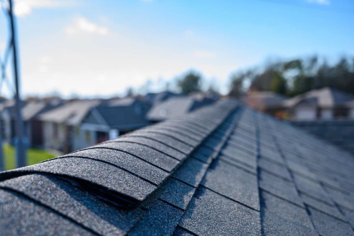 Close-up of ridge-cap shingles along a roof peak