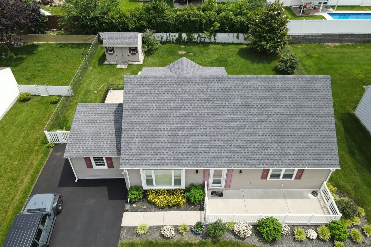Aerial view of a home with a new gray shingle roof