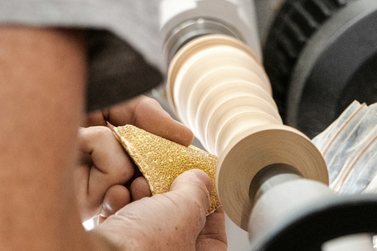 Sanding a turned piece on a lathe