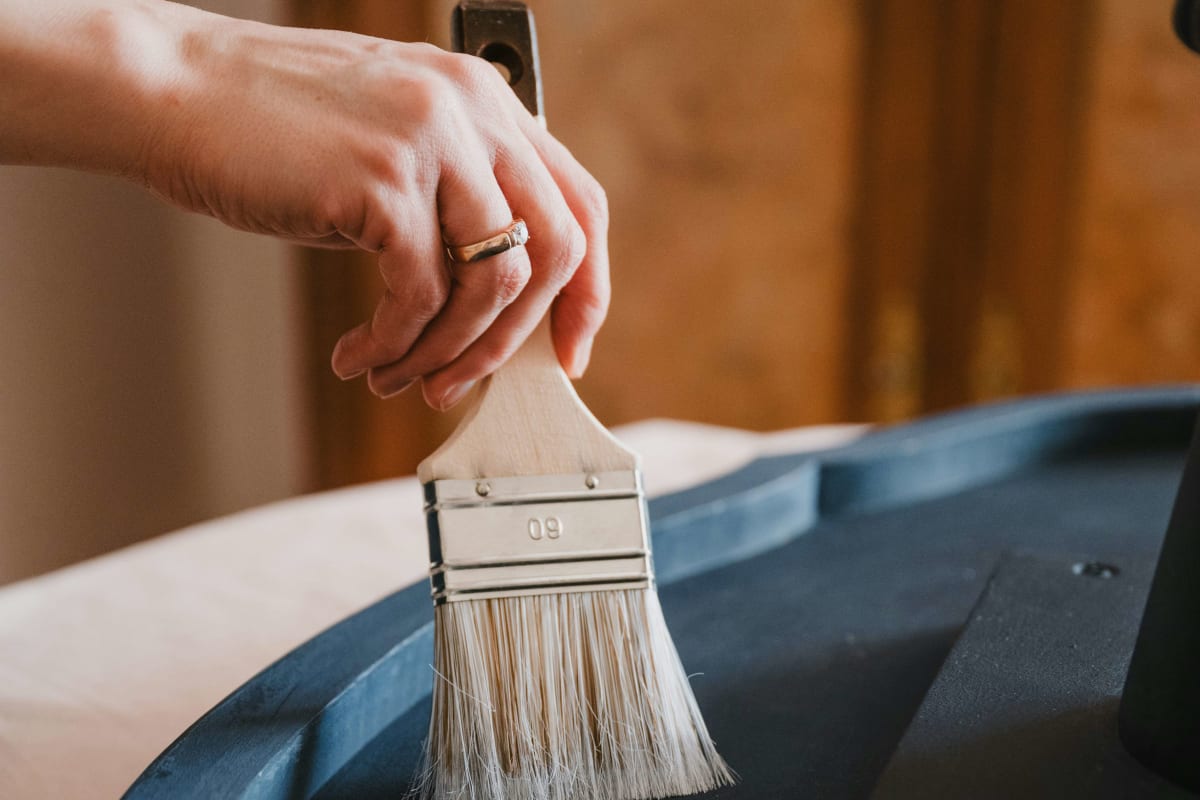 Brushing a dark finish onto furniture