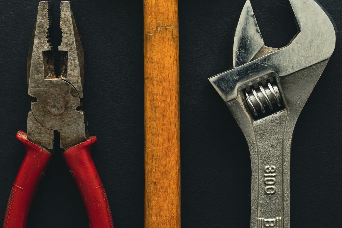 Pliers, hammer and adjustable wrench