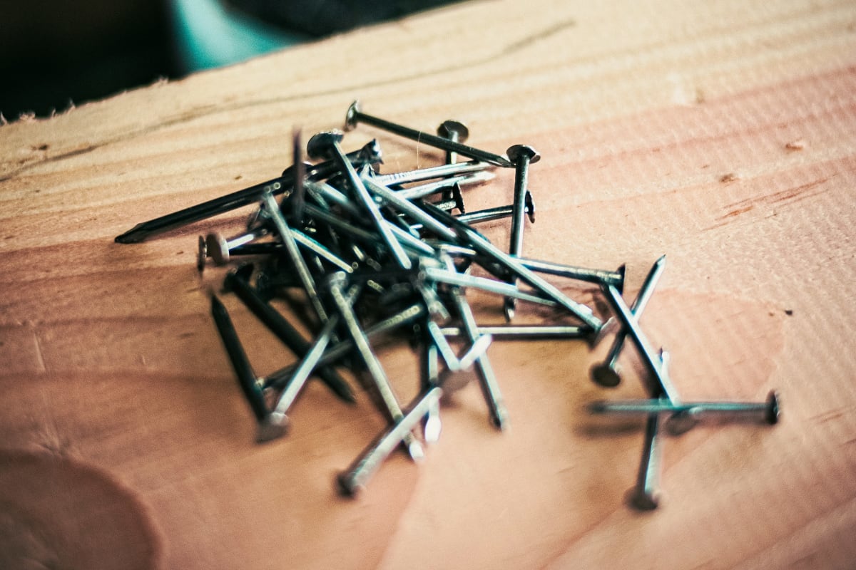 Nails scattered on fresh lumber