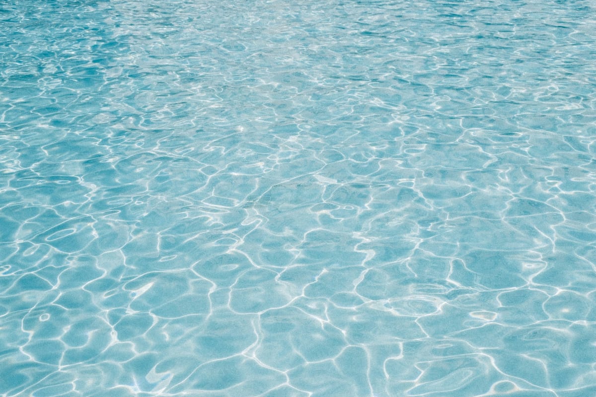 Sunlit ripples in clear pool water
