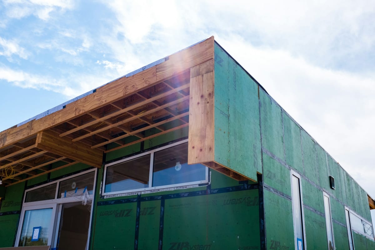 New building wrapped in green sheathing