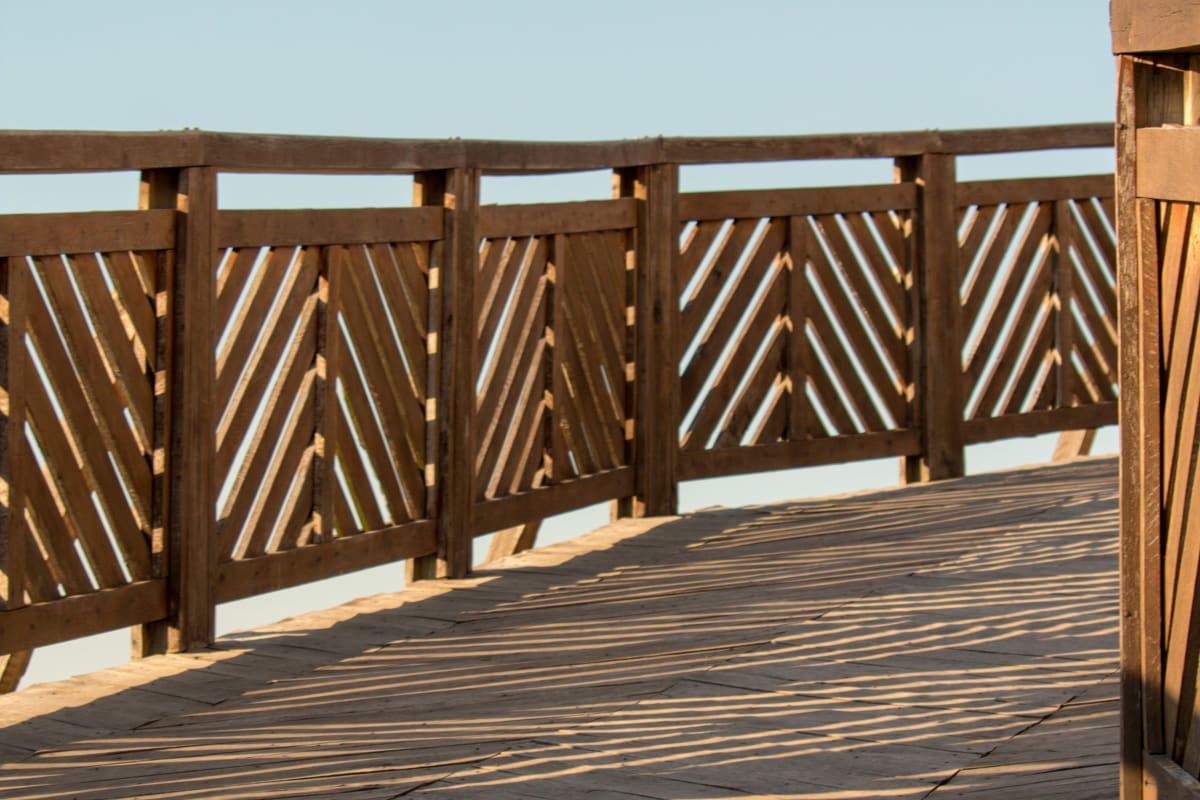 Hardwood deck with slatted wood railing
