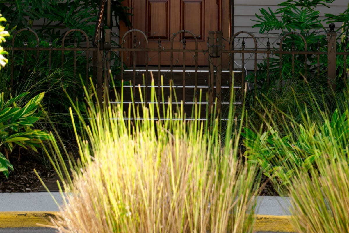 Craftsman wood entry door on a gray-sided home