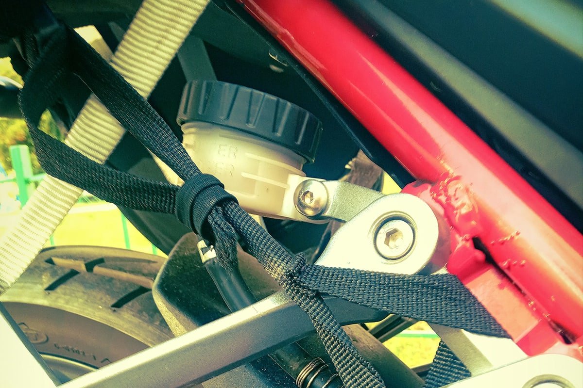 Motorcycle tied down with straps