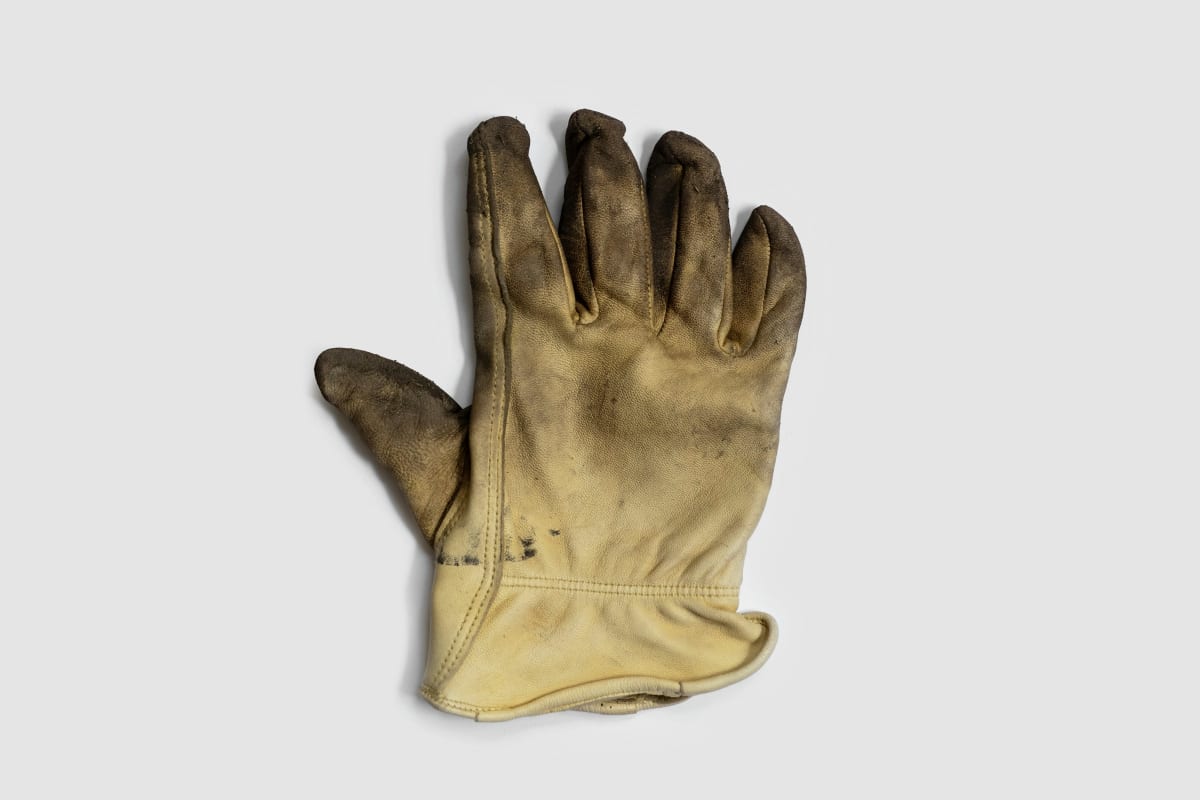 Well-worn yellow leather work glove