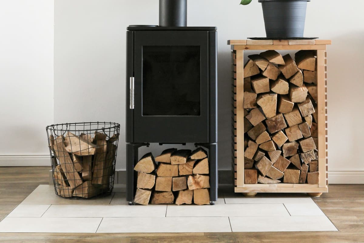 Black wood stove with a woodpile