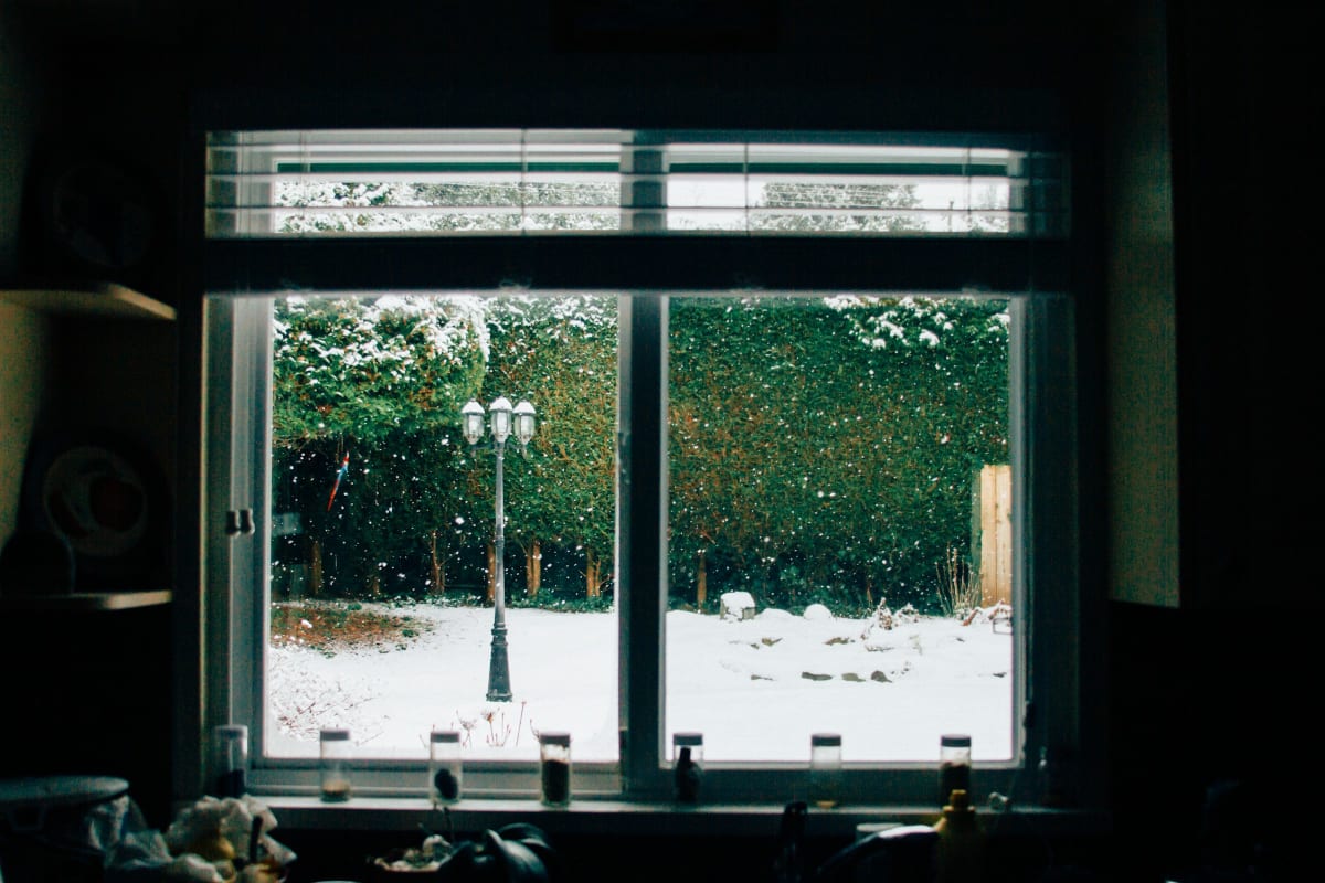 Snowy yard through a well-sealed window