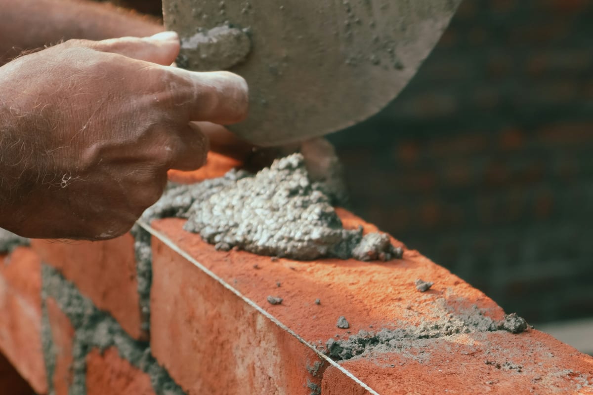 Mason holding a trowel of mortar