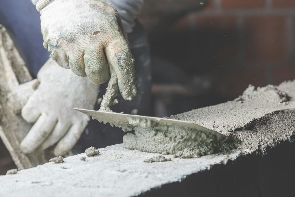 Spreading concrete with a trowel