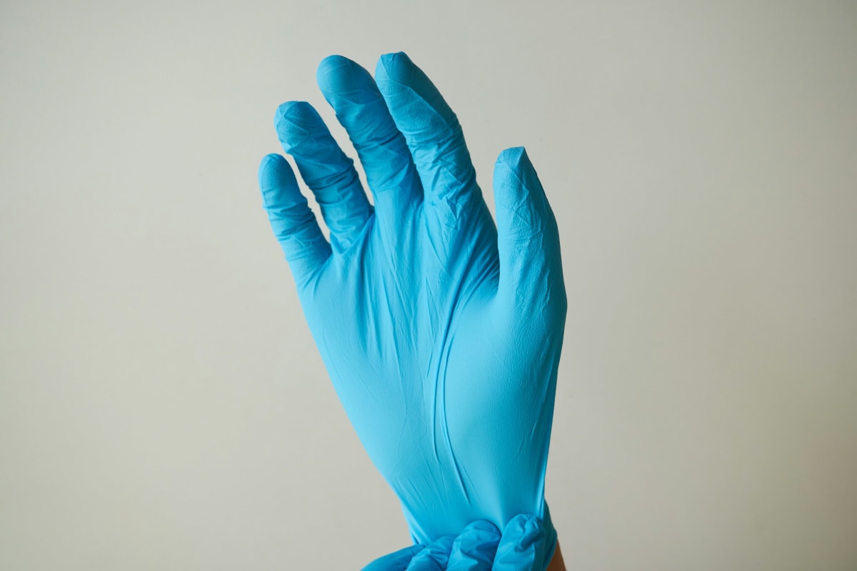 Pulling on a nitrile glove