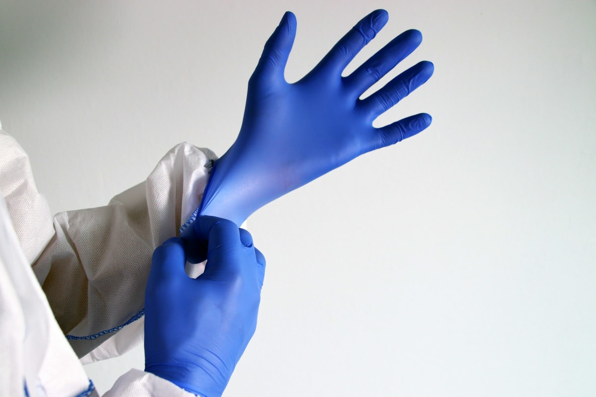 Pulling on protective gloves