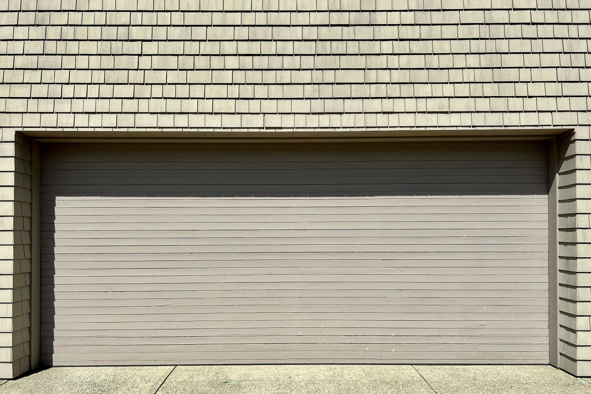 Wide garage door under shingle siding