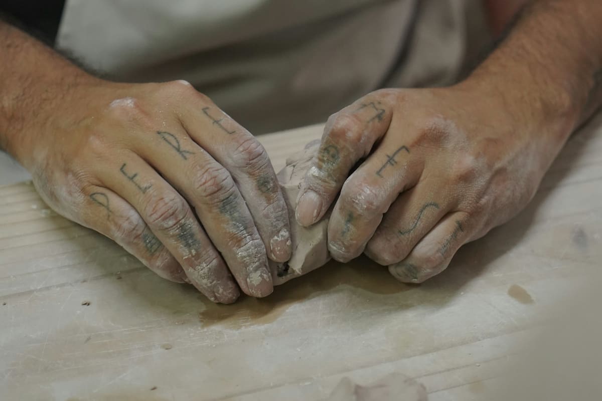 Working hands resting on a bench