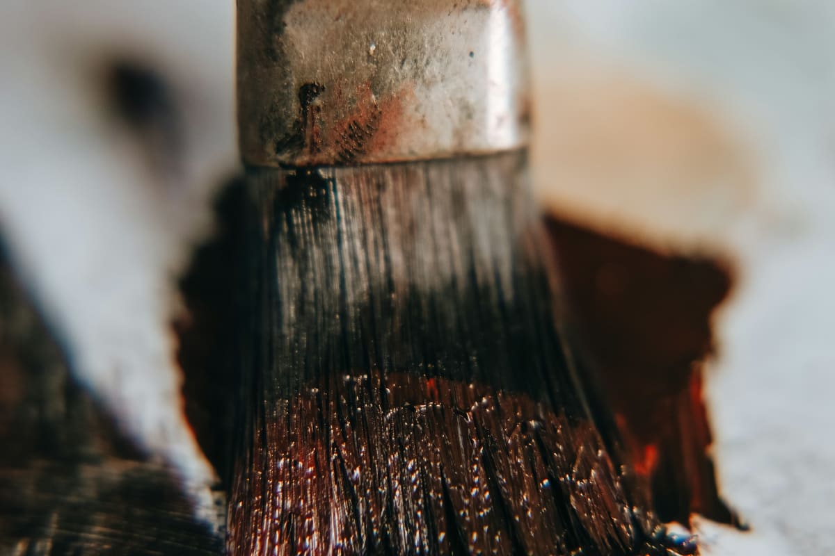 Brush loaded with dark wood stain