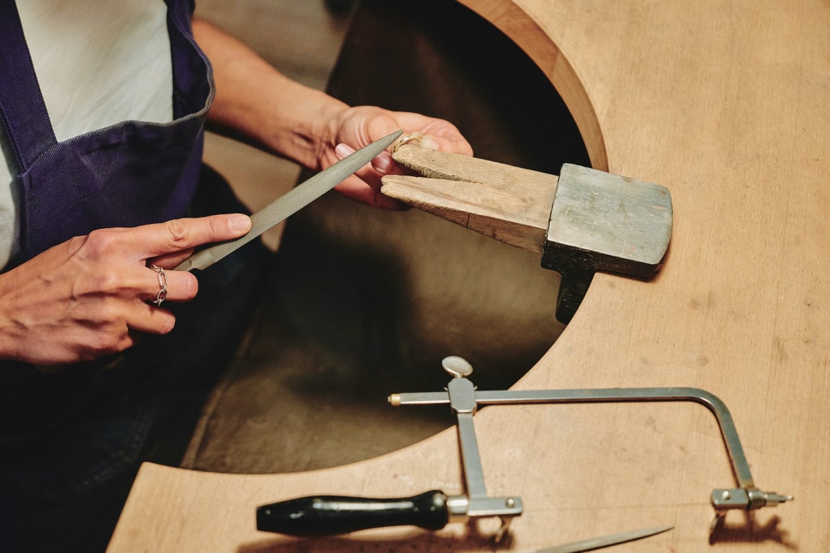 Coping saw and files on a woodworking bench