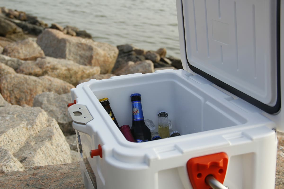 Cooler full of drinks on the rocks by the water