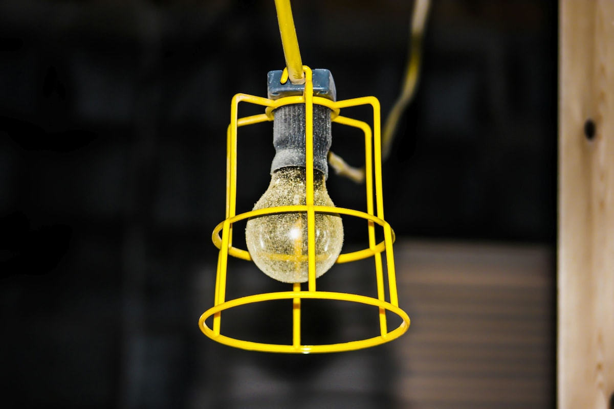 Caged work light hanging on a job site